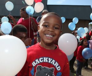 Smiling little boy with balloons