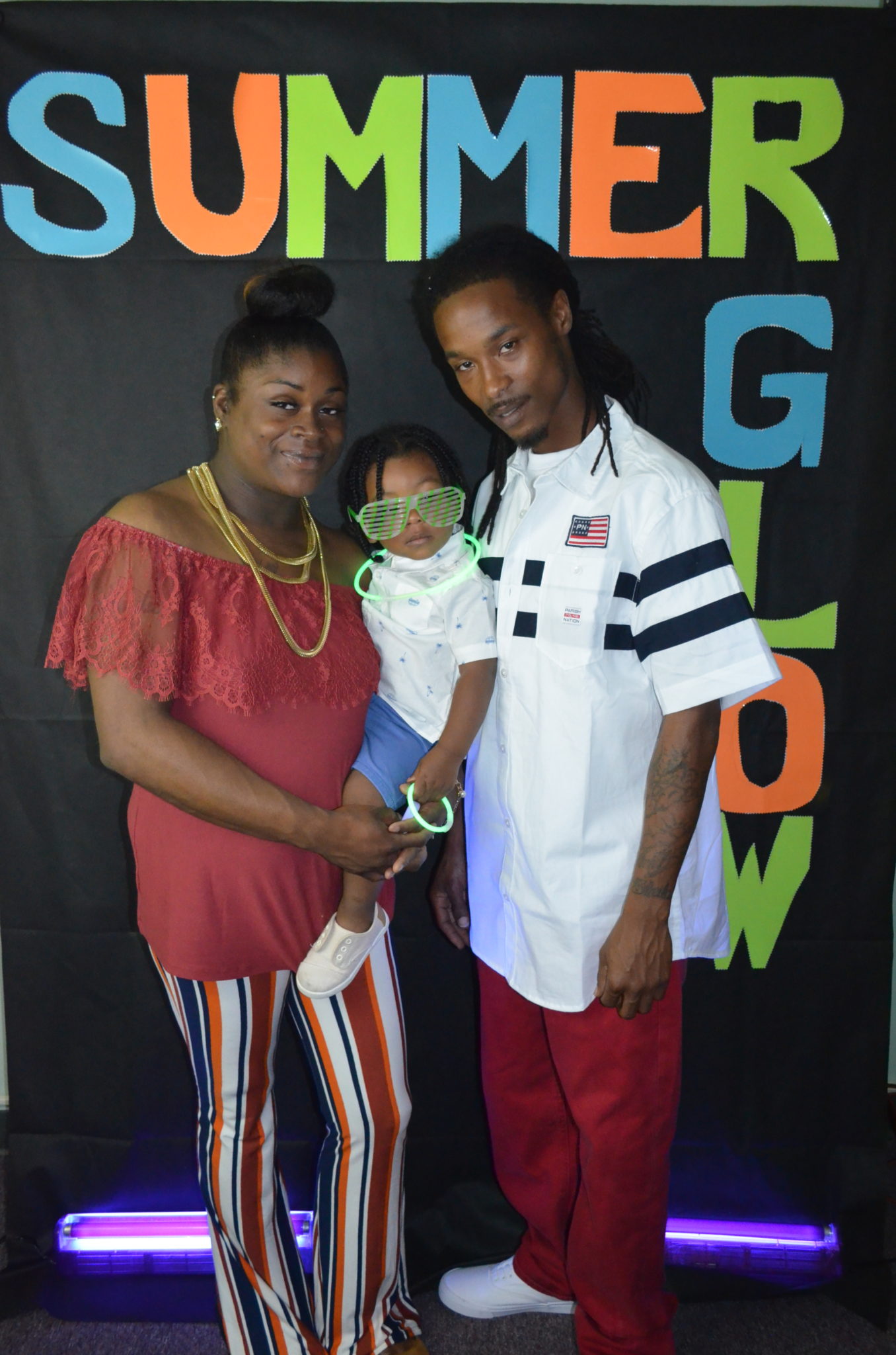family posing for photo in front of Summer Glow Background