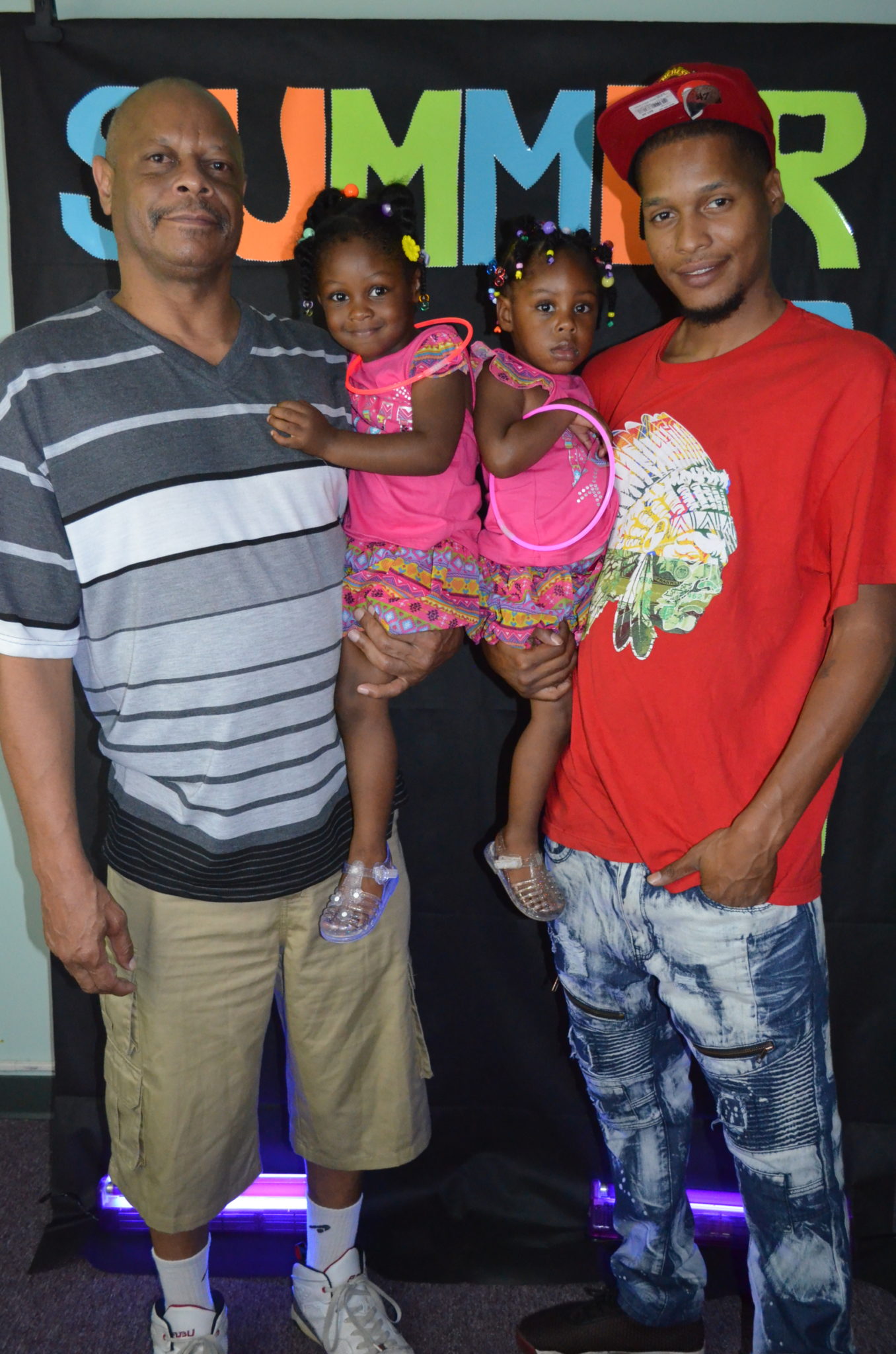 family posing for photo in front of Summer Glow Background