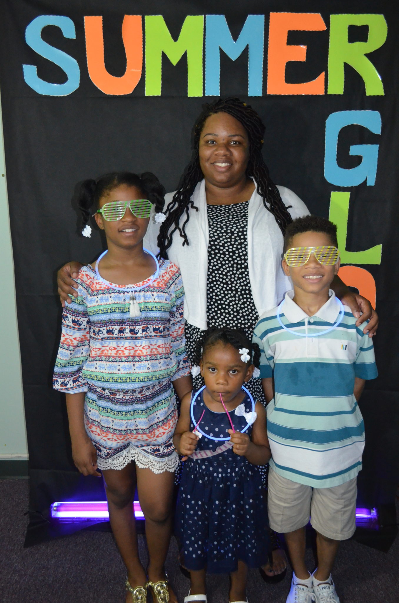 family posing for photo in front of Summer Glow Background