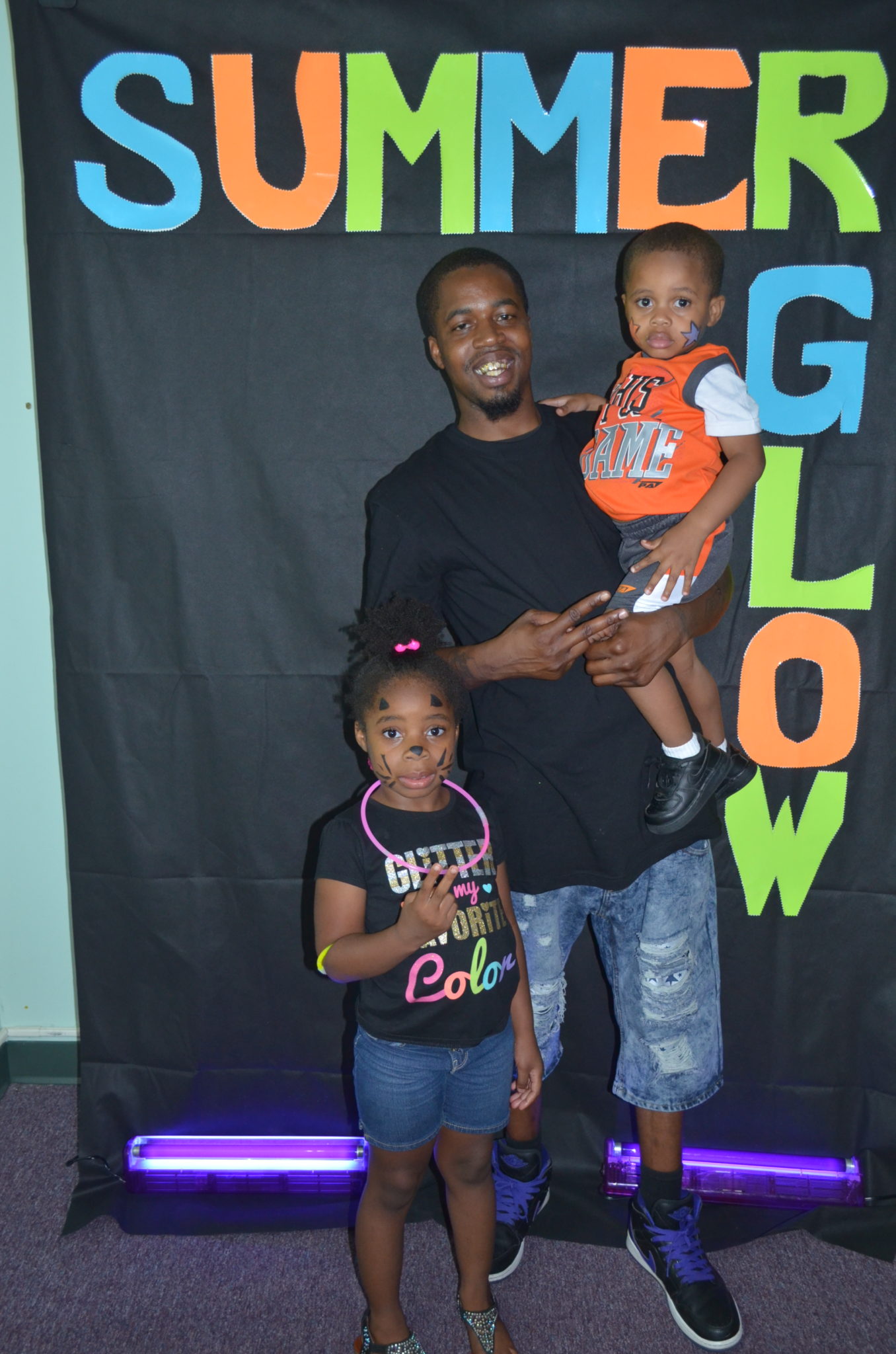 family posing for photo in front of Summer Glow Background