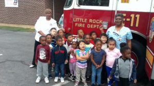a class in front of a firetruck