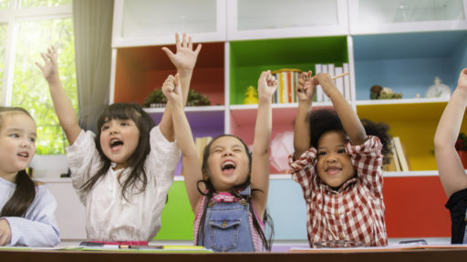Group of multi-ethnic five little kids children African American, asian and Caucasian happiness together with friend to draw colour pencil to full colour of picture in living room or class room