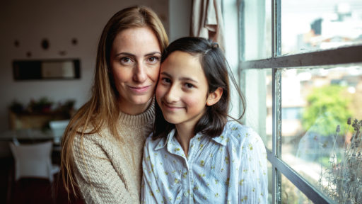 parent and child sitting and posing for a photo