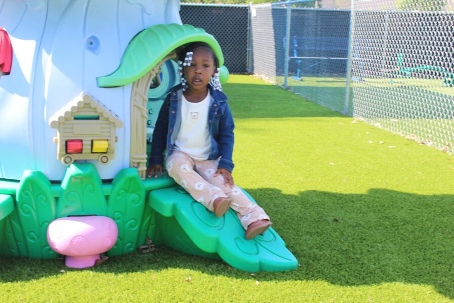 Little girl is outside enjoying the new playground slide.