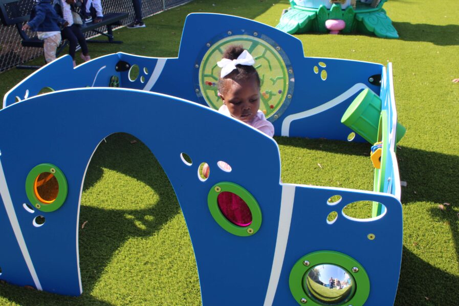 Little girl playing in the new playground equipment.