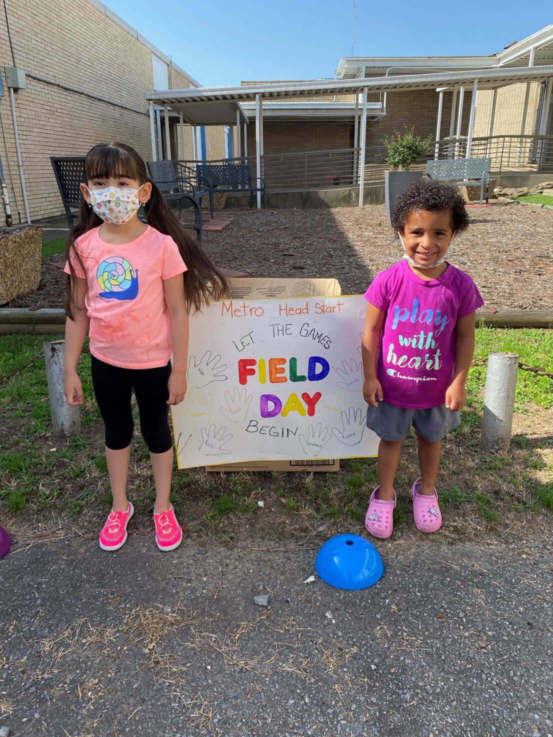 To children standing on either side of a hand-made sign that says Field Day