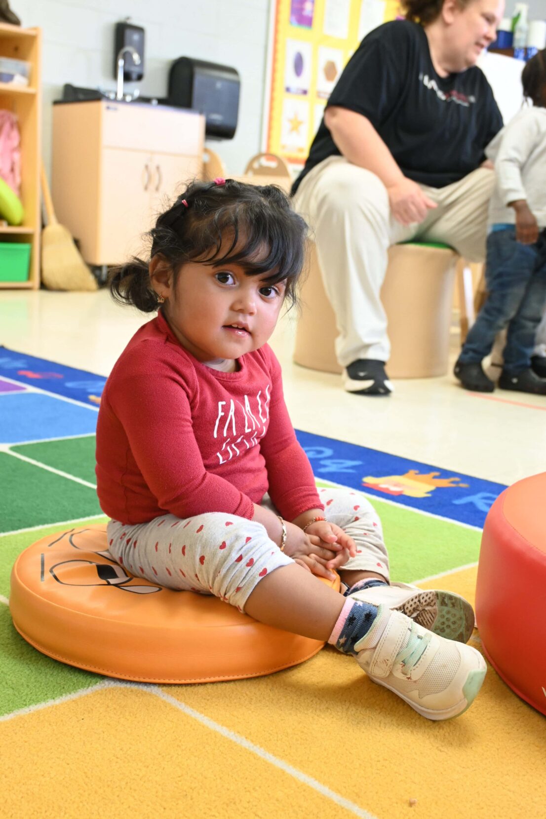 little girl enjoying some carpet play time.