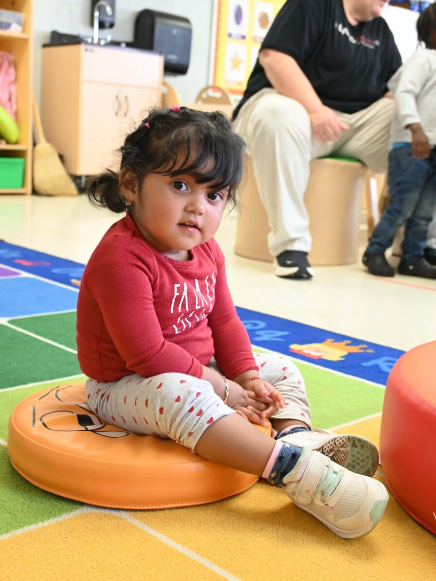 little girl enjoying some carpet play time.