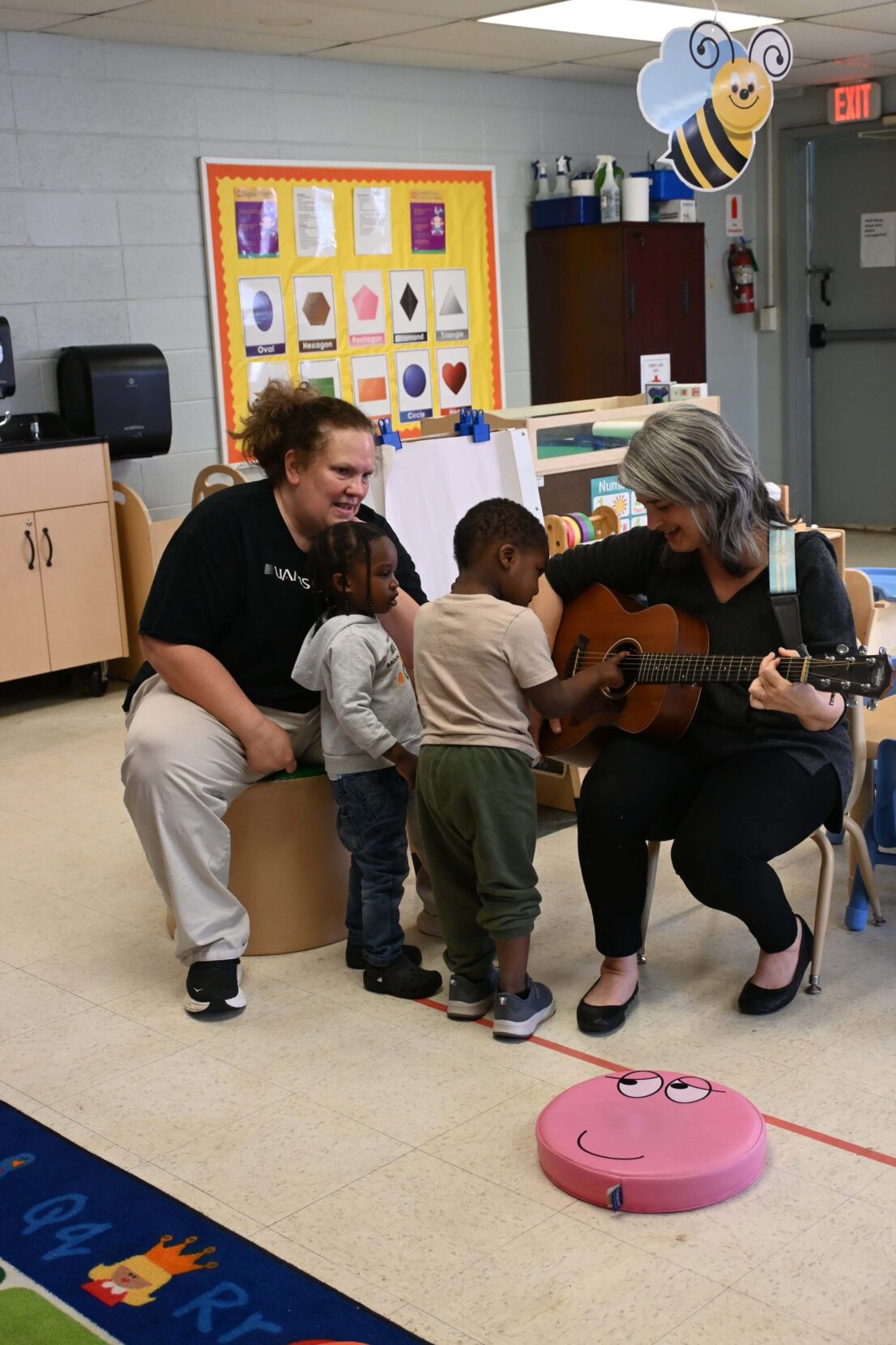 At Kennedy Head Start, JoAnn Kelt from the Arkansas Symphony Orchestra brought the #instrumentzoo for children to be able to explore different instruments. For Early Head Start, Virginia Ralph from mömandpöp brought her guitar and sang songs with the children and let them strum her guitar.