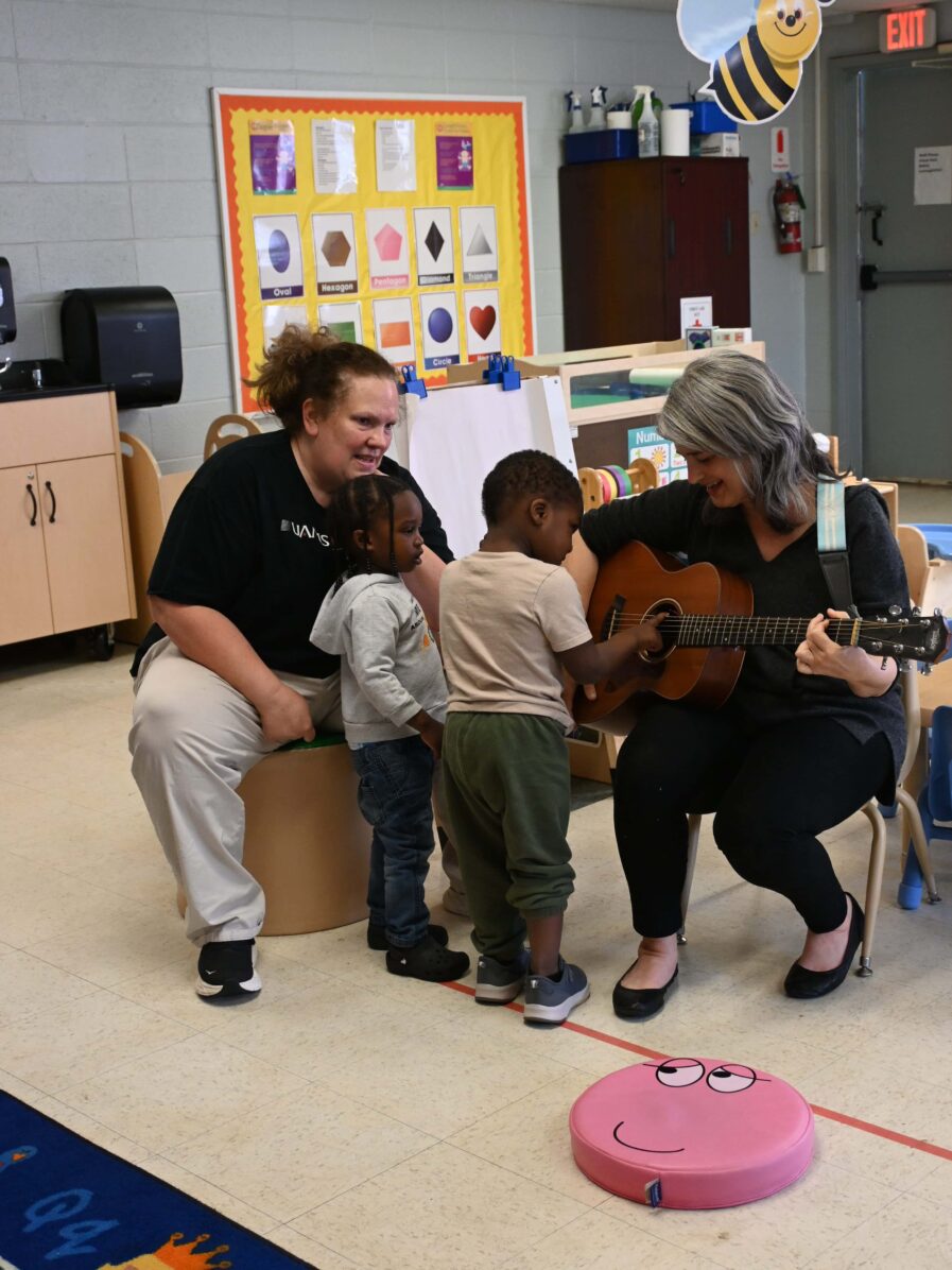 At Kennedy Head Start, JoAnn Kelt from the Arkansas Symphony Orchestra brought the #instrumentzoo for children to be able to explore different instruments. For Early Head Start, Virginia Ralph from mömandpöp brought her guitar and sang songs with the children and let them strum her guitar.