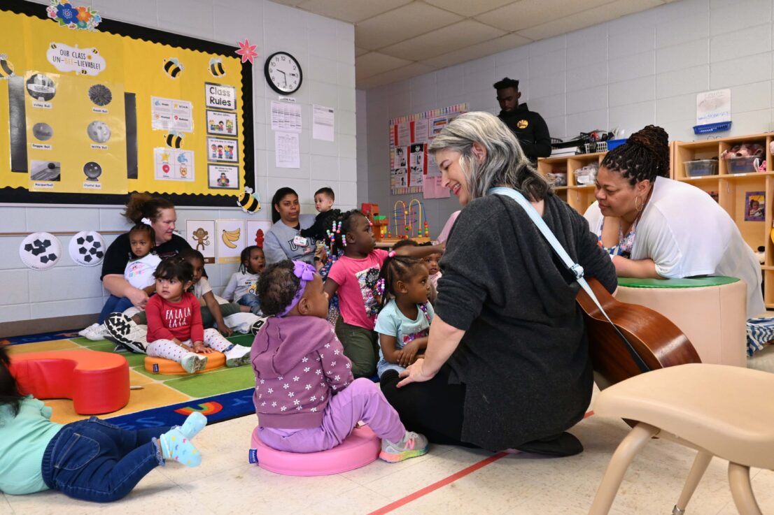 Virginia Ralph from mömandpöp brought her guitar and sang songs with the children and let them strum her guitar.