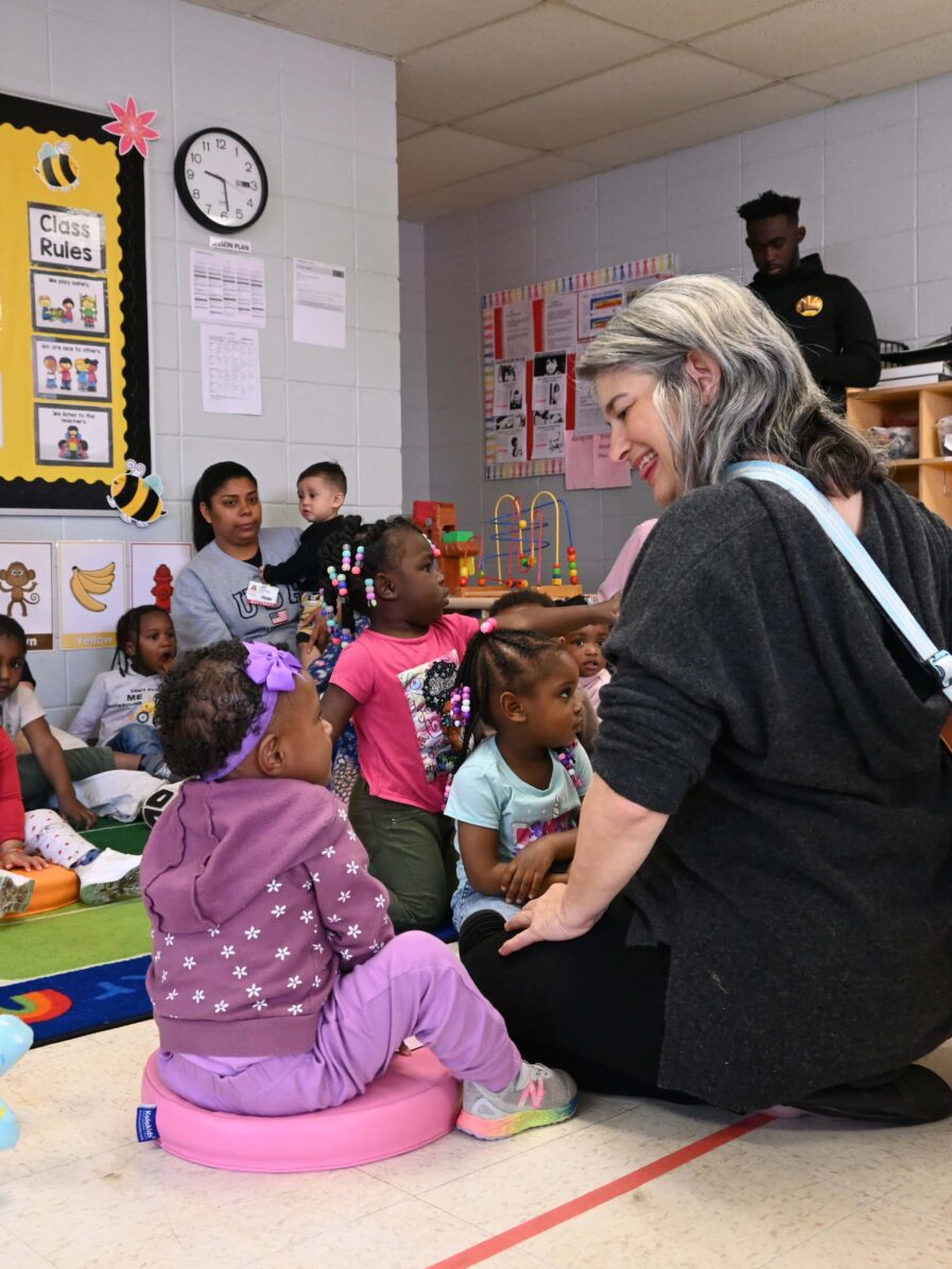 Virginia Ralph from mömandpöp brought her guitar and sang songs with the children and let them strum her guitar.