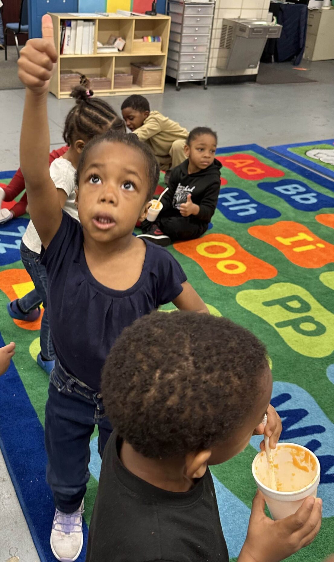 Student gives a thumbs up after trying the carrot smoothie